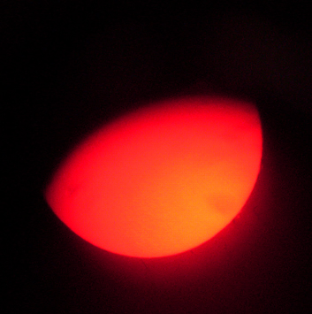Afocal hand held shot showing small flare at 3:15 and 4:30.